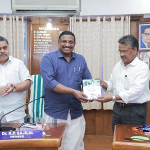 Hon. Chairman Dr. M R Byju released the Handbook on Physical Measurement & Physical Efficiency Test handing over to Dr.K.P Sajilal, Hon.Member on 07/08/2023